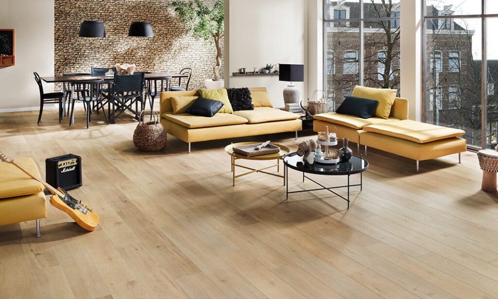 Modern living room with light wood laminate flooring and yellow sofas